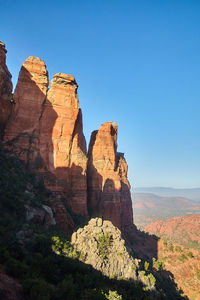 Rock formations on mountain against clear blue sky