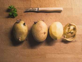 High angle view of raw potatoes on wooden table