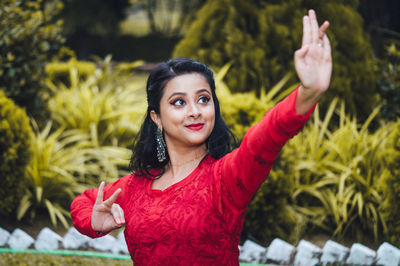 Portrait of smiling young woman standing outdoors