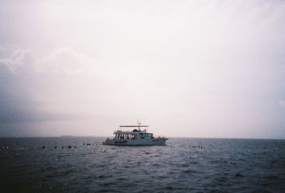 Boat sailing in sea against sky