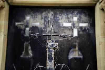 Close-up of old metal hanging at temple