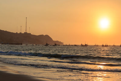 Scenic view of sea against clear sky during sunset