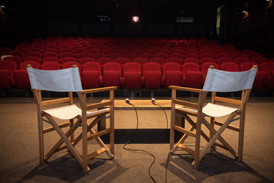 Empty chairs and table on stage