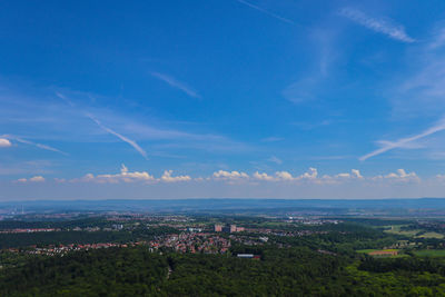 Aerial view of cityscape against blue sky