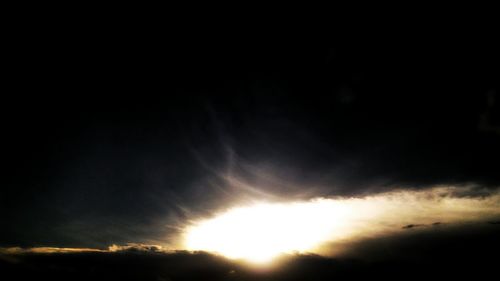 Scenic view of silhouette sun in sky