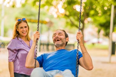 Portrait of boy swinging at playground