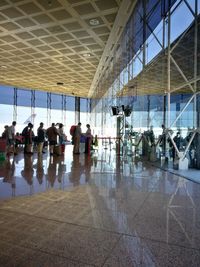 People at airport against sky