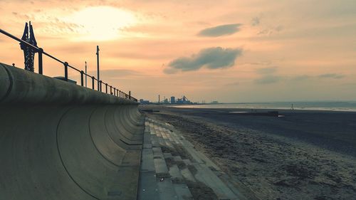 Scenic view of beach against sky during sunset