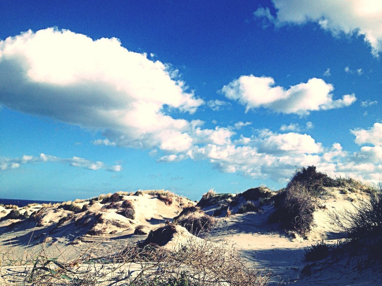 sky, tranquil scene, scenics, tranquility, beauty in nature, sea, water, nature, blue, cloud - sky, cloud, rock - object, idyllic, beach, rock formation, day, rock, remote, non-urban scene, outdoors