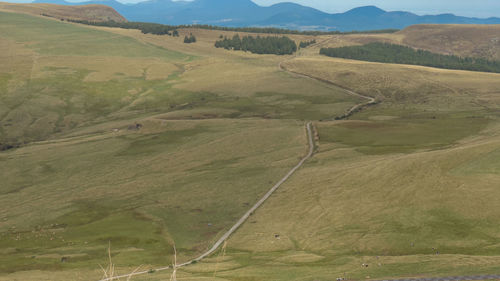 High angle view of road amidst field against sky