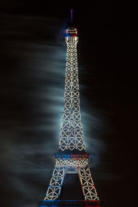 Close-up of illuminated tower against sky at night