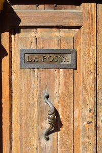 Close-up of text on wooden door