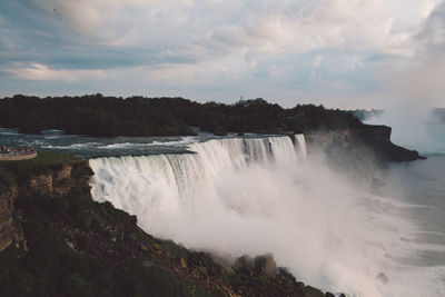 Scenic view of waterfall against sky