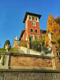Low angle view of building against clear blue sky