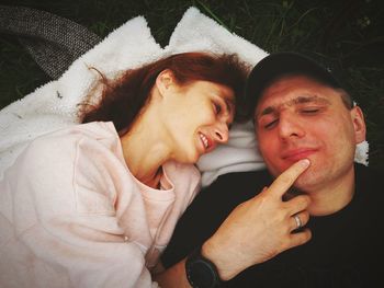 High angle view of romantic couple lying on bed at home