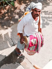 High angle portrait of man playing drum outdoors