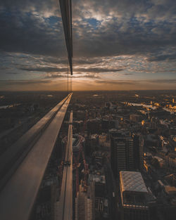 Aerial view of cityscape against sky during sunset