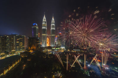 Firework display in city at night