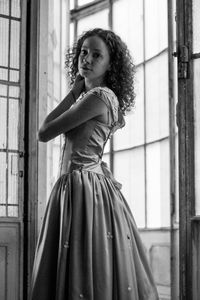 Portrait of young woman standing indoors