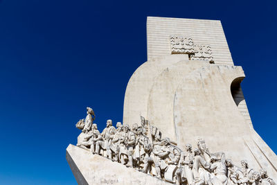 Low angle view of statue against blue sky