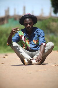 Portrait of young man sitting outdoors