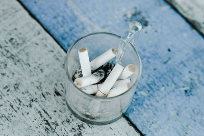 High angle view of cigarette on water
