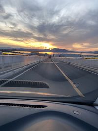 View of road from car against sky during sunset