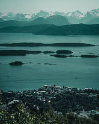 Scenic view of sea and mountains against sky