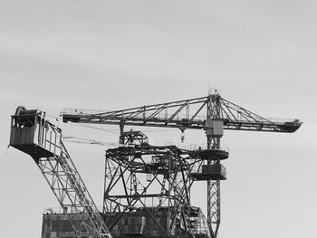 Low angle view of crane against sky