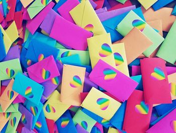 Full frame shot of colorful envelopes with heart shape