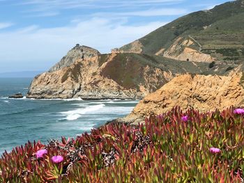 Scenic view of sea and mountains against sky