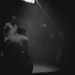 Full length of woman in dark room