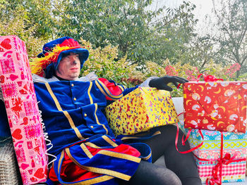 Midsection of woman with multi colored sitting outdoors