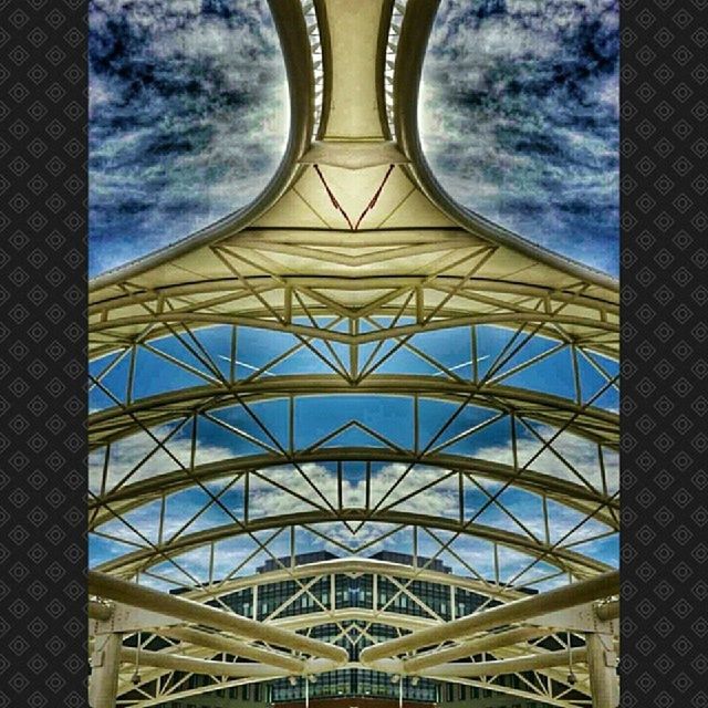 architecture, built structure, low angle view, sky, architectural feature, pattern, modern, cloud - sky, building exterior, famous place, design, glass - material, travel destinations, indoors, city, metal, capital cities, tower, geometric shape, international landmark