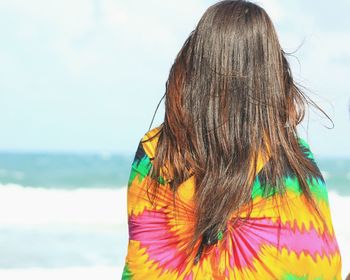 Rear view of person standing against sea