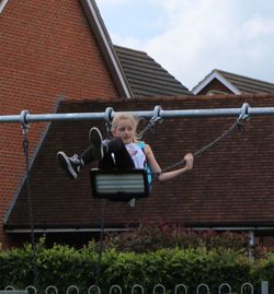 Full length of woman standing by railing