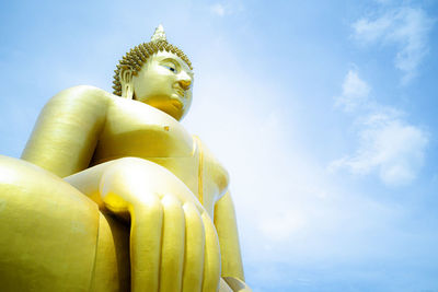 Low angle view of statue of buddha against sky