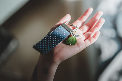 Close-up of woman holding hand with decoration