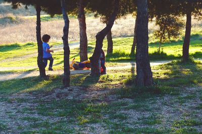 Children playing on swing in park