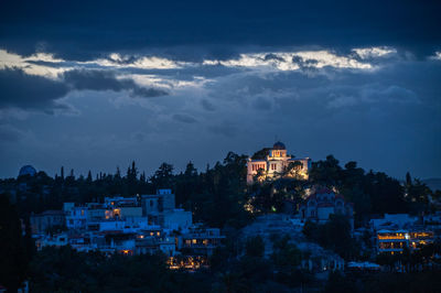 Illuminated cityscape against sky at night