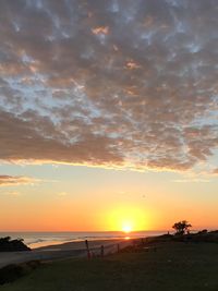 Scenic view of beach against sky during sunset