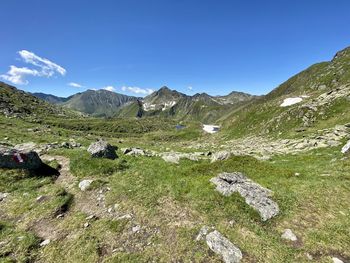 Scenic view of mountains against blue sky