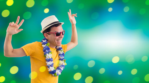 Portrait of smiling young woman wearing sunglasses