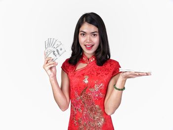 Portrait of a smiling young woman against white background