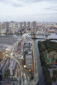 High angle view of road amidst buildings in city against sky