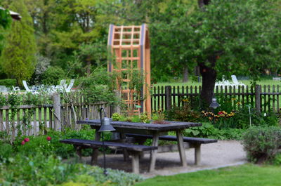 Empty chairs and table in yard