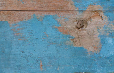 Old vintage blue painted wood background with peeling paint