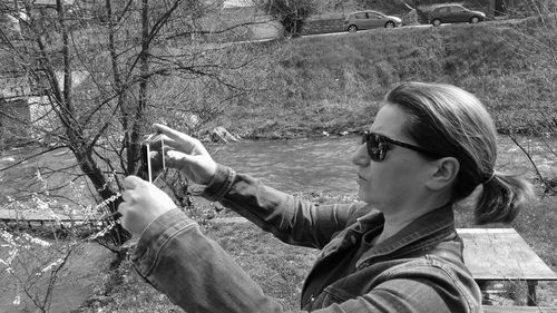 Close-up of woman taking picture through mobile phone