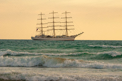 Sailboat sailing in sea against sky