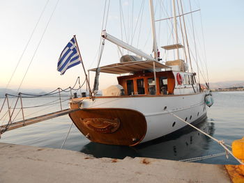 Sailboat moored in sea against sky